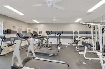 A spacious gym with treadmills, elliptical machines, and other exercise equipment