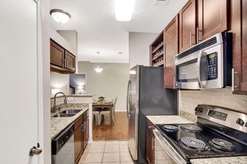 A kitchen with wooden cabinets and stainless steel appliances