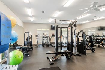 A fitness room with weights and other exercise equipment