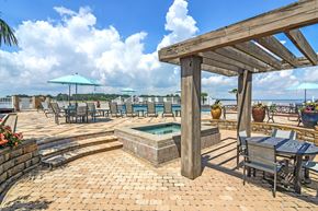 Brandon apartment for rent - the patio has a hot tub and tables with umbrellas at Lakeshore Pointe Apartment Homes, Brandon, MS, 39047