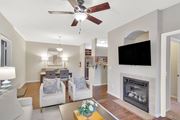 Flowood apartment for rent - a living room with a fireplace and a ceiling fan at Ashford Place Apartment Homes, Flowood, MS 39232