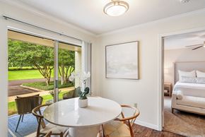 Oxford apartment for rent - a dining area with a table and chairs and a bedroom with a bed at Cambridge Station Apartment Homes, Mississippi