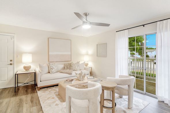 Olive Branch apartment for rent - a living room with white furniture and a ceiling fan at The Oliver Apartment Homes, Olive Branch, MS