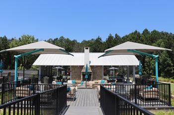 A patio with a white canopy and a black railing
