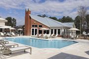 Flowood apartment for rent - A pool with a building behind it at Carlton Park Apartment Homes in Flowood, MS 