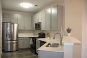 Flowood apartment for rent - A kitchen with a stainless steel refrigerator and a white countertop at Carlton Park Apartment Homes in Flowood, MS