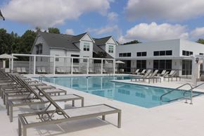 Brandon apartment for rent - A pool with sun loungers and a building in the background.