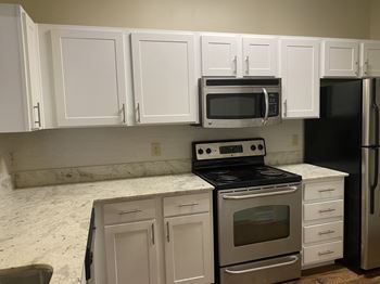 A kitchen with white cabinets