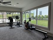 Laurel apartment for rent - a home gym with exercise equipment and large windows at Laurelwood Apartment Homes, 39440