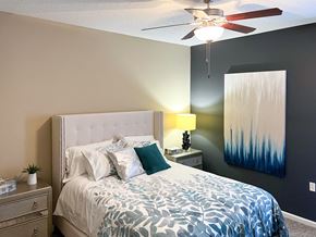 Shreveport apartment for rent - a bedroom with a bed and a ceiling fan at Canebrake Apartment Homes in Shreveport, Louisiana, 71115
