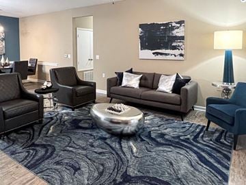 Shreveport apartment for rent - a living room with couches and chairs and a rug