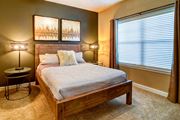 Williston apartment for rent - a bedroom with a bed and a window at The Retreat Apartment Homes in Williston, North Dakota