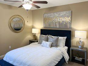 Bossier City apartment for rent - a bedroom with a large bed and a ceiling fan at Reserve of Bossier City Apartment Homes in Bossier City, LA 
