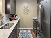 Bossier City apartment for rent - a kitchen with stainless steel appliances and granite counter tops at Reserve of Bossier City Apartment Homes in Louisiana 71111