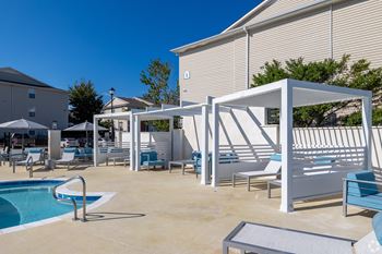 A pool area with sun loungers