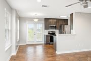 Hattiesburg apartment for rent - A kitchen with a refrigerator, microwave, and stove top oven. at Reserve at Park Place Apartment Homes, Hattiesburg, MS, 39402