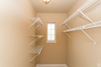 A room with a window and shelving units