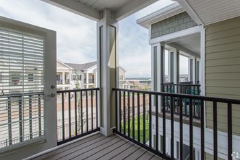 A balcony with a view of the sky and houses