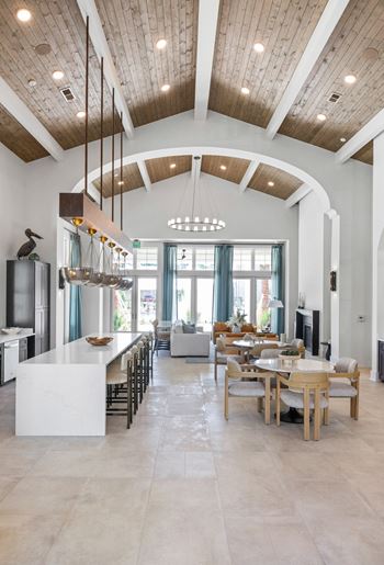 A modern kitchen with a dining table and chairs.