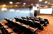 Ocean Springs apartment for rent - a conference room filled with chairs and a projector screen at Reserve at Gulf Hills Apartment Homes in Ocean Springs, Mississippi