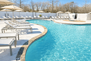 Tyler apartment for rent - A large swimming pool surrounded by sun loungers and umbrellas.