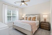 Hattiesburg apartment for rent - a bedroom with a bed and a ceiling fan at The Met Apartment Homes, Mississippi 39402