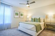 Brandon apartment for rent - a bedroom with a bed and a ceiling fan at The Vineyard at Castlewoods Apartment Homes in Brandon, MS 39047