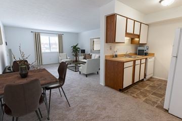 Louisville apartment for rent - an open living room and kitchen with a dining room table and chairs