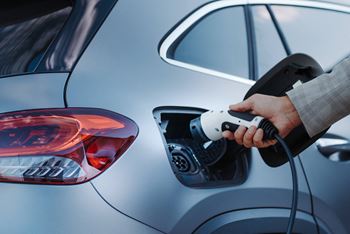 A person is charging an electric car.