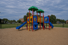 Louisville apartment for rent - A playground with a blue slide and a yellow and red play structure.