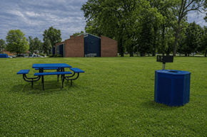 Louisville apartment for rent - A blue picnic table sits on a grassy field.