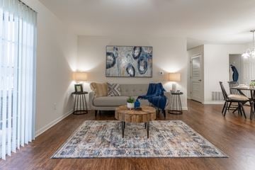 Greenwood triplex for rent - a living room with a couch and a table