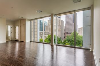 Living room with floor to ceiling windows and a view of the city