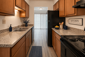 Indianapolis apartment for rent - A kitchen with wooden cabinets and granite countertops.