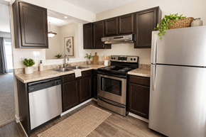 Springboro townhouse for rent - A kitchen with dark brown cabinets and stainless steel appliances.