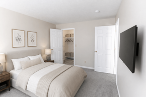 Springboro townhouse for rent - A bedroom with a large bed and a flat screen TV mounted on the wall.