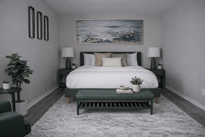 Indianapolis apartment for rent - A bedroom with a large bed and a painting on the wall.
