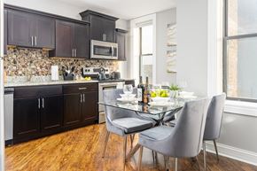Chicago apartment for rent - Kitchen with black cabinets and a table and chairs at Somerset Place Apartments, Chicago