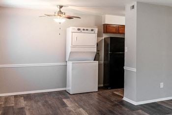 A white washer and dryer in a room with a ceiling fan