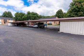 A parking lot with a car in front of a building