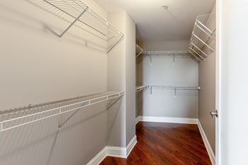 Walk in closet with white shelves