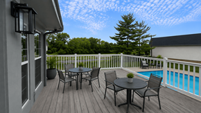 Fairfield apartment for rent - A table and chairs set on a deck overlooking a pool.