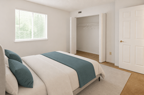 Indianapolis apartment for rent - A bedroom with a bed, a window, and a closet.