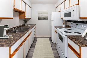Kokomo apartment for rent - a kitchen with white appliances and granite counter tops at Walnut Creek Apartments, Kokomo, 46902