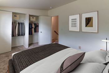 A bedroom with a large bed and a closet