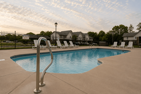 Indianapolis apartment for rent - A swimming pool with a metal ladder in the foreground.