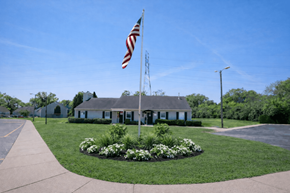 Indianapolis townhouse for rent - A flag is flying in front of a building with a grey roof.