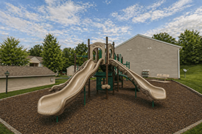Springboro townhouse for rent - A playground with a green slide and brown ground.