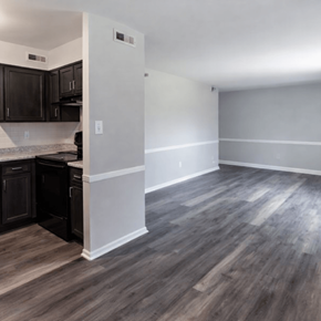 Indianapolis apartment for rent - A kitchen with dark wood cabinets and a white wall.