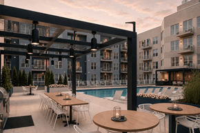 Indianapolis apartment for rent - A modern outdoor dining area with tables and chairs is set up next to a pool.